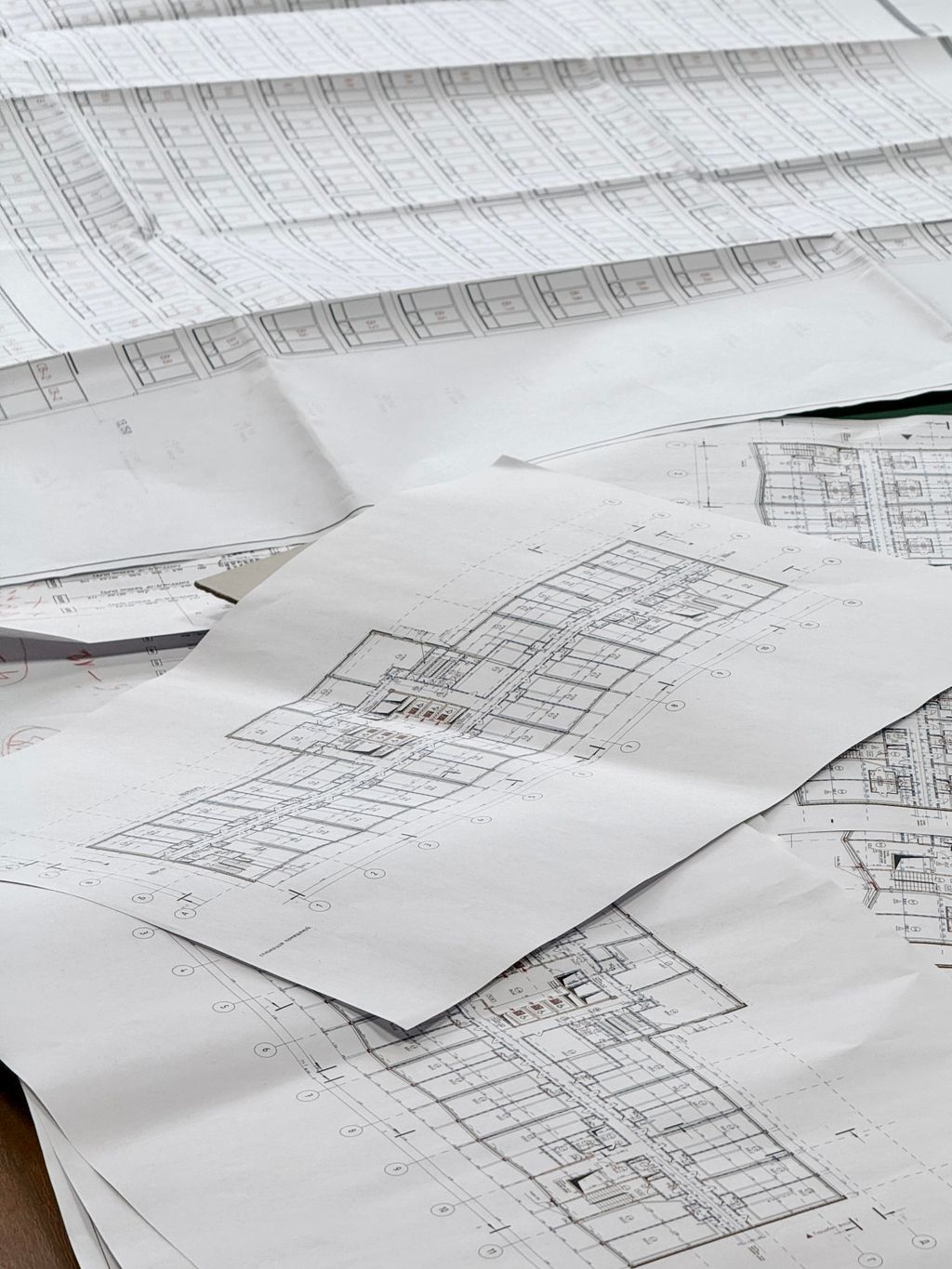Architectural plans spread across a desk.