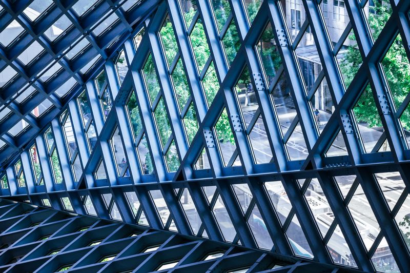 Steel beams form the structure of a glazed building.